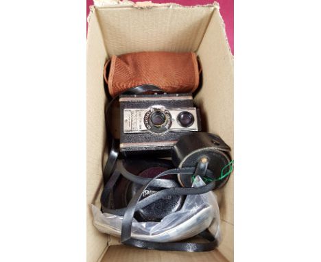 A box containing three vintage cameras 