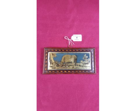 A 19th Century reverse print on glass depicting a bull in country landscape within an inlaid frame 