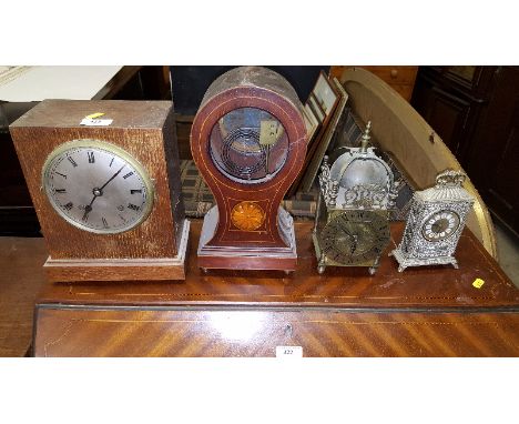 A 17th Century style brass lantern clock; an oak two hole mantel clock; a mahogany inlaid clock case and a brass clock