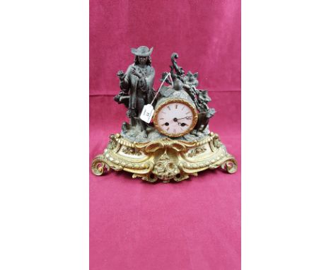 A late 19th Century French spelter two hole mantel clock mounted with a figure 