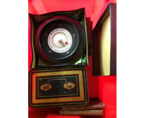 A box containing a miniature roulette wheel; a tin of brass ornaments; a simulated pearl necklace etc. 