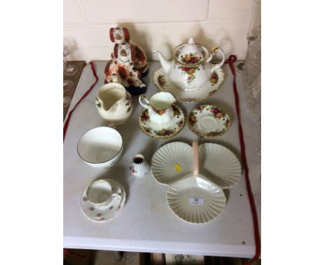 A quantity of Royal Albert 'Old Country Roses' china; a pair of Victorian Staffordshire spaniel ornament; a small Poole potte
