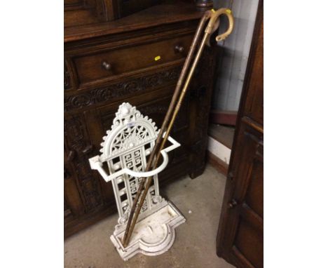 A Victorian cast iron stick stand and two shepherd's crooks