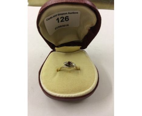 An 18ct gold diamond and red stone set ring