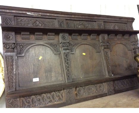 A carved oak triple panel