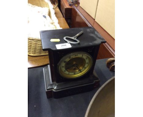A late Victorian black slate and rouge marble single hole mantel clock - key on rostrum 