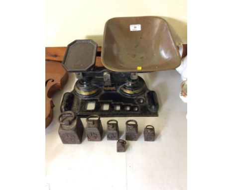 A set of old cast iron kitchen scales and graduated weights