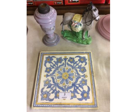 A Staffordshire model horse; a late Victorian glass oil lamp base and a floral decorated tile