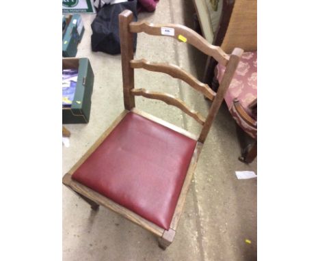 A pair of oak ladder back dining chairs 