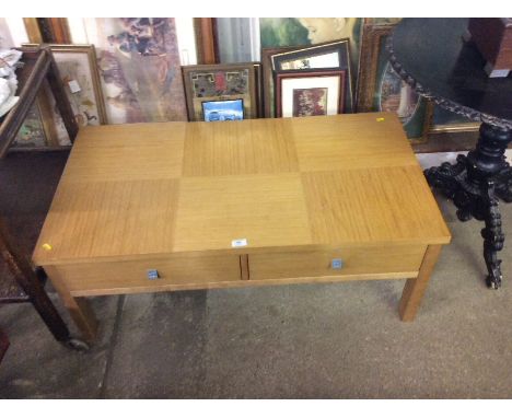 A light oak effect coffee table fitted two drawers 