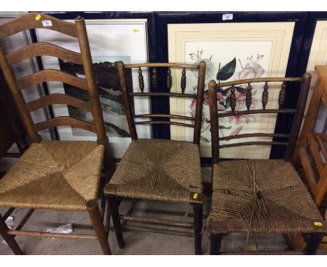 An oak and rush seated ladder back dining chair and two string seated chairs