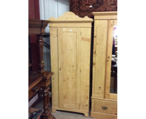 A Victorian stripped pine single door wardrobe 