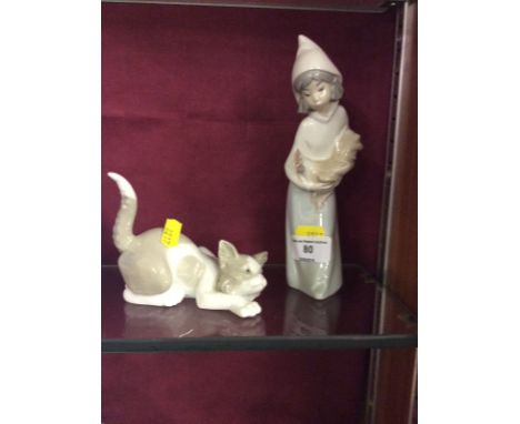 A Lladro figurine of a young girl holding a chicken and one other in the form of a cat