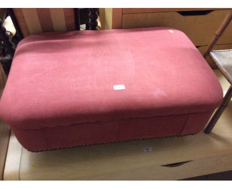 An upholstered pouffe