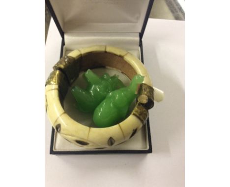 An Eastern style bangle and two elephant ornaments