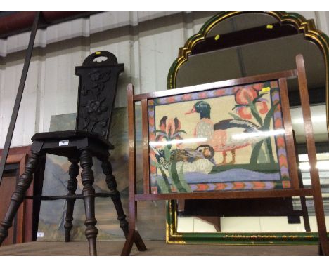 A Victorian carved oak spinning chair and a mahogany and needlework firescreen 