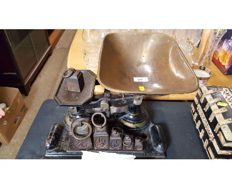 A set of cast iron kitchen scales with set of graduating weights