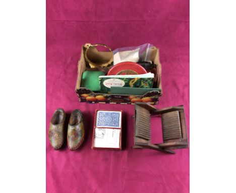 A box containing carved wooden clogs; playing cards and various sundries