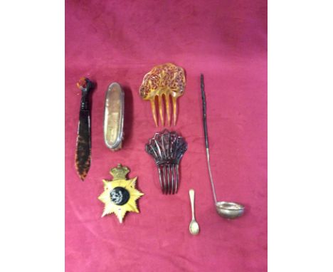 A box containing a 19th Century white metal and whale bone handled toddy ladle; a silver mounted brush; hair clips etc.