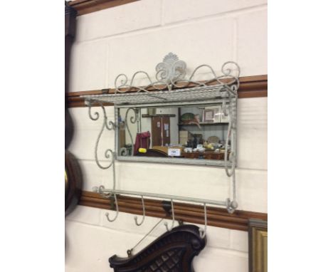 A metal framed and mirrored set of coat hooks 