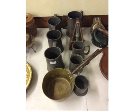 A pewter pig; various pewter tankards; a brass saucepan and a metronome 