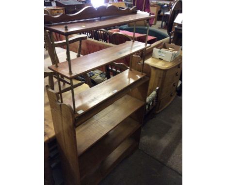 A stripped pine bookcase together with a three tier mahogany and brass wall shelf