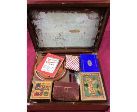 An Art Deco box and contents of various games to include solitaire board, draughts, Ludo etc.