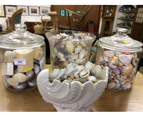 Two glass jars; a vase of shells and soaps and a white glazed shell vase and contents