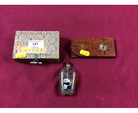 A modern Chinese snuff bottle decorated with a panda; and a Chinese wooden compass 