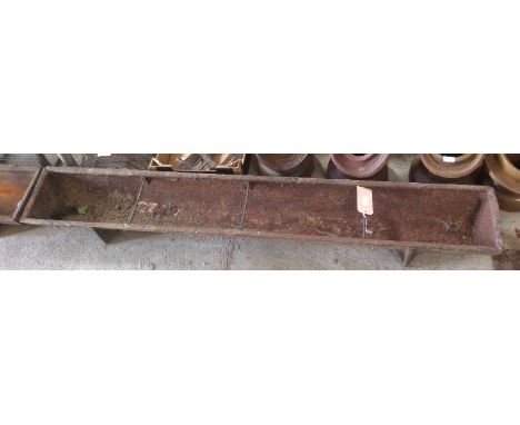 A long cast iron pig trough