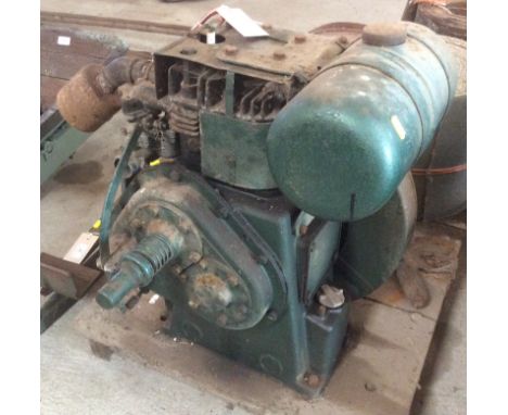A 1.5HP Petter stationary engine, on wooden plinth