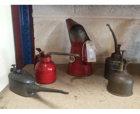 An Esso oil jug and four other small oil cans
