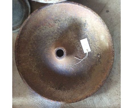 A small cast iron circular pig trough 