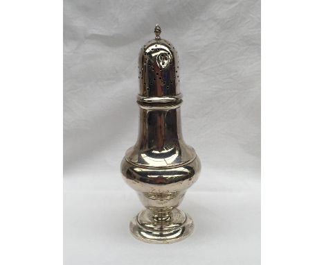 An Edward VII silver sugar caster of baluster form with a flame finial and pierced domed lid on a spreading foot, Birmingham,