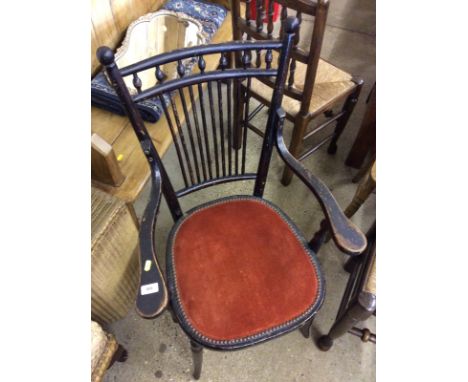 An ebonised stick back elbow chair 