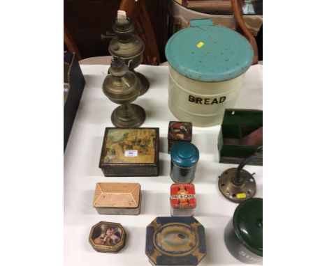 Two brass oil lamp bases; an enamel bread bin; a brass three branch ceiling light and various tins