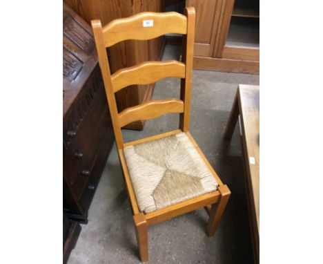 A set of four beech and rush seated ladder back dining chairs 