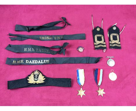 A tray containing two WW2 stars; two WW1 medals; a pair of epaulettes; cap tallies etc.
