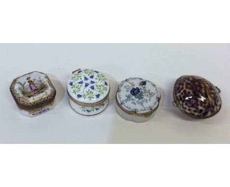 A Limoges snuff box decorated with flowers together with three other boxes similar. Est. £20 - £30.