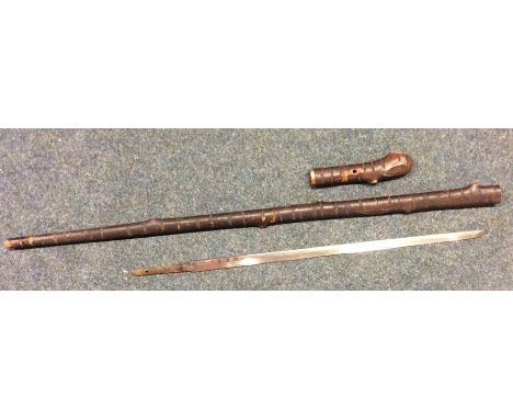 An unusual Japanese sword stick of bark form with signed steel blade. Approx. 86 cms long. Est. £300 - £400.