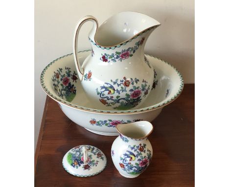A decorative jug and basin set with floral decoration. Est. £15 - £20.