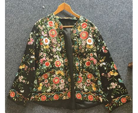 An Oriental style jacket with extensive floral embroidered decoration and loop button flowers. Est. £20 - £30.