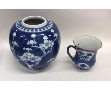 A Chinese blue and white vase together with a tapering cup. Est. £30 - £50.