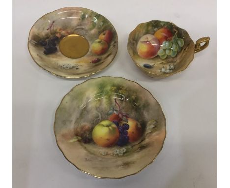 A Royal Worcester hand painted cabinet cup and saucer together with a plate. By Ricketts. Est. £25 - £35. 