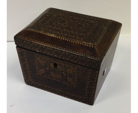 A parquetry tea caddy of shaped form with fitted interior. Est. £50 - £80.
