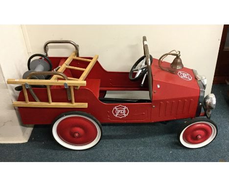 A child's toy fire engine with chrome decoration. Est. £25 - £35.