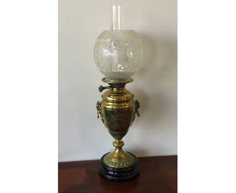A tall brass oil lamp with etched shade. Est. £30 - £50.