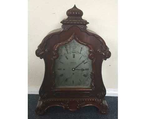 An impressive Victorian mahogany bracket clock attractively decorated with scrolls and flowers to shaped silvered dial and en