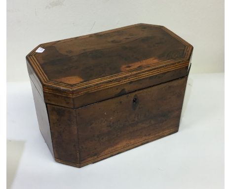 A Georgian mahogany tea caddy with crossbanded decoration and cut corners. Est. £20 - £30.