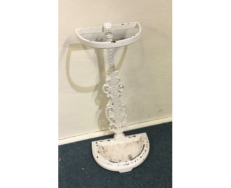 A small white painted stick stand with scroll decoration. Est. £15 - £20.